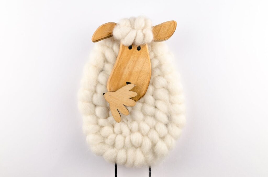 pexels photo 1420706 Charming sheep ornament crafted from wool and wood, perfect for decoration.
