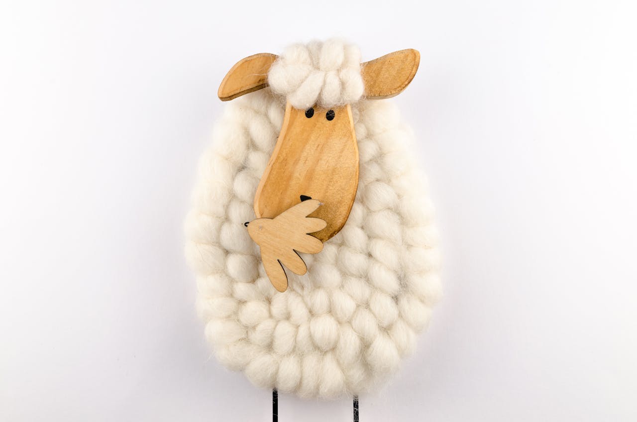 room-03 Charming sheep ornament crafted from wool and wood, perfect for decoration.