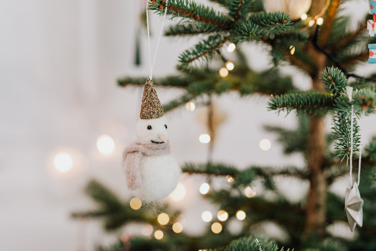 Cozy Christmas ornament on a tree with glowing lights in a festive setting.